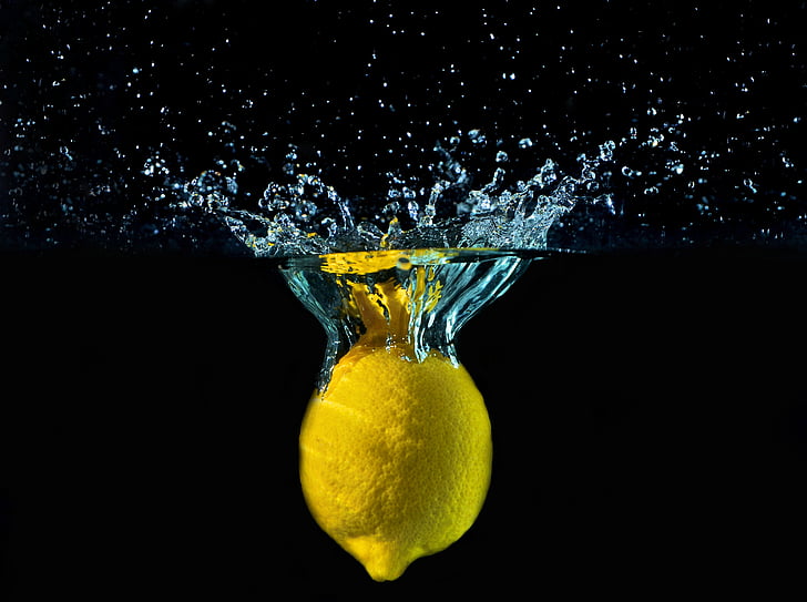 yellow lemon dropped in body of water