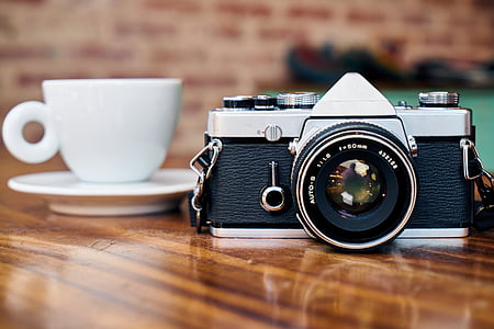 panoramic photography of DSLR camera in front of teacup and saucer