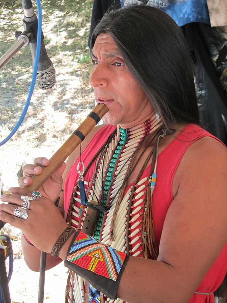 Native American Indian playing bamboo flute