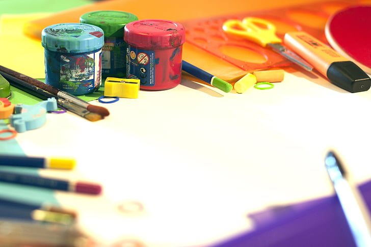 assorted colored paint bottles and art brush with scissors