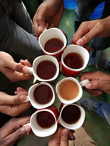 seven person standing holding coffee mugs
