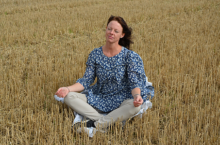 woman wearing blue top in grass field