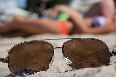 brown Aviator sunglasses on sand