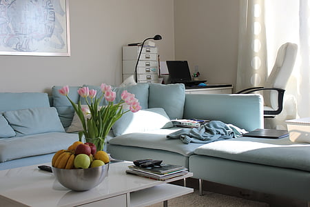 grey sectional couch with flowers on center table