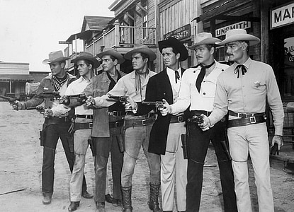 graysale photo of men holding rifles