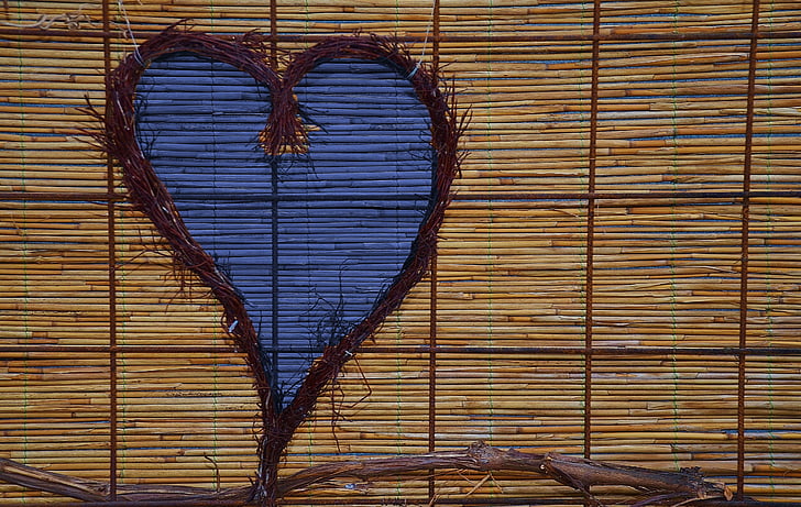 heart-shaped brown twig wreath on bamboo blind