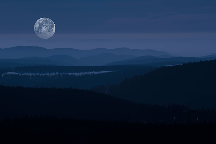 photography of mountain range under full moon