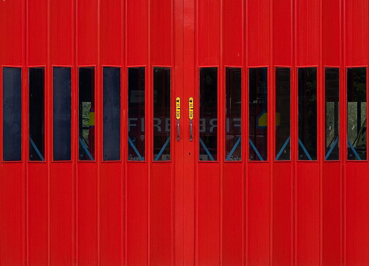 closed red wooden doors with glass at daytime