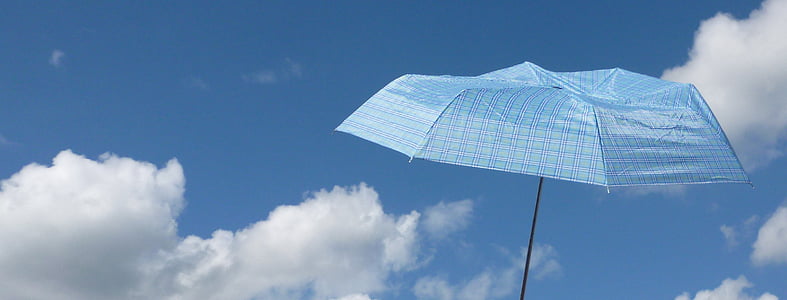 blue umbrella with sky background