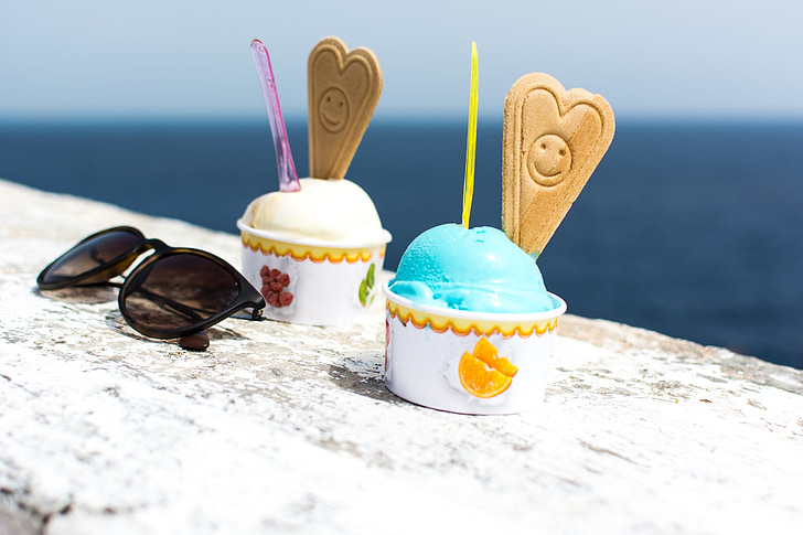 two ice creams beside black framed sunglasses