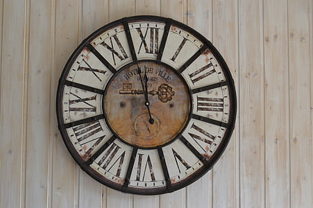 round white and brown roman analog wall clock