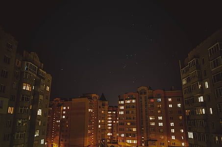 buildings under stars during nighttime