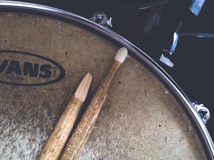 brown drumsticks on brown Vans snare drum