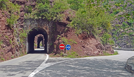 gray tunnel near concrete road at daytime