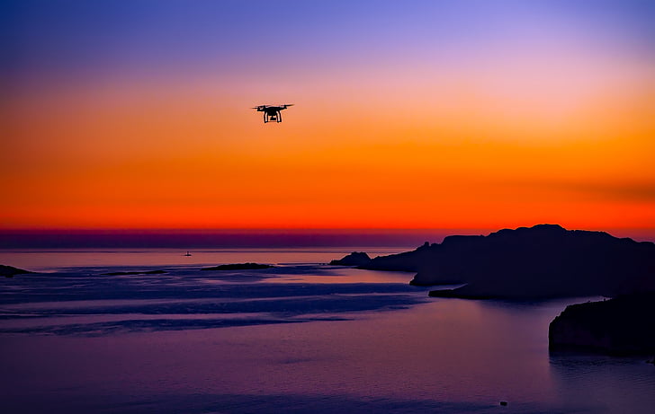 black RC quadcopter photo during sunset