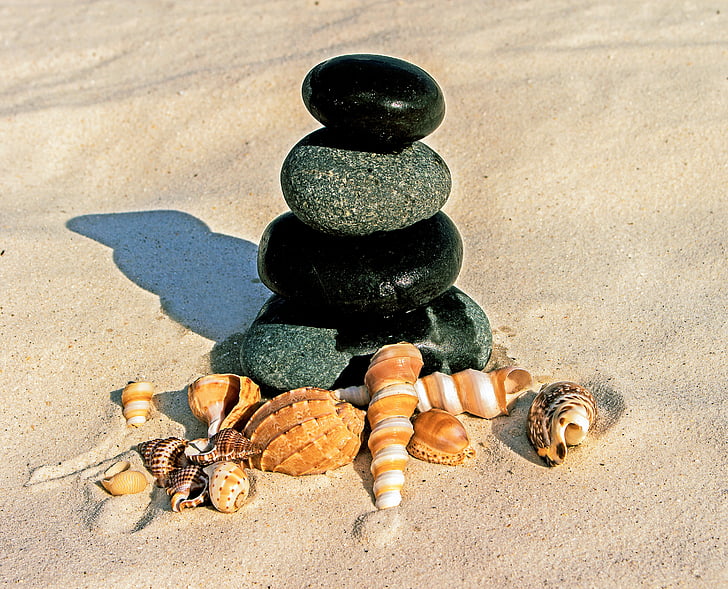 stone stack and shell on sand