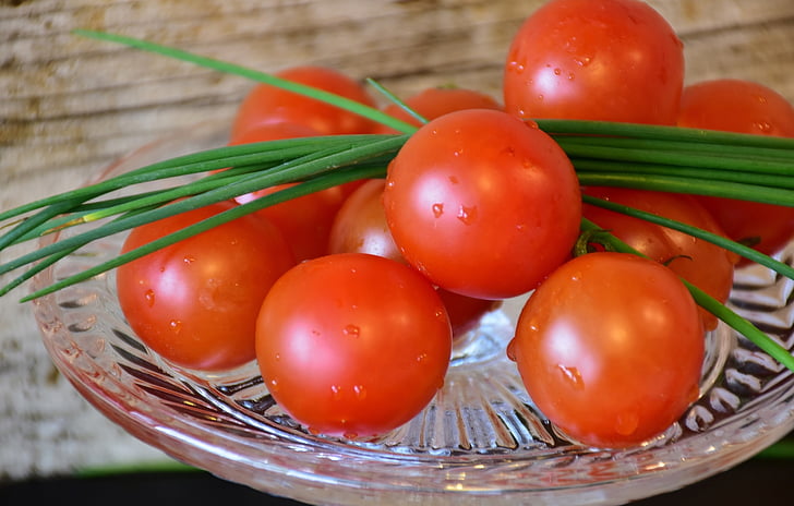 orange tomatoes on round glass plate
