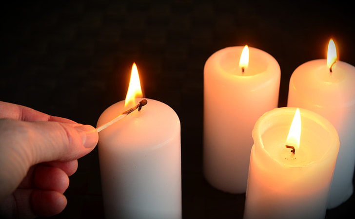 four lighted pillar candles