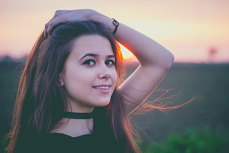 selective focus photography of woman wearing black top during dusk