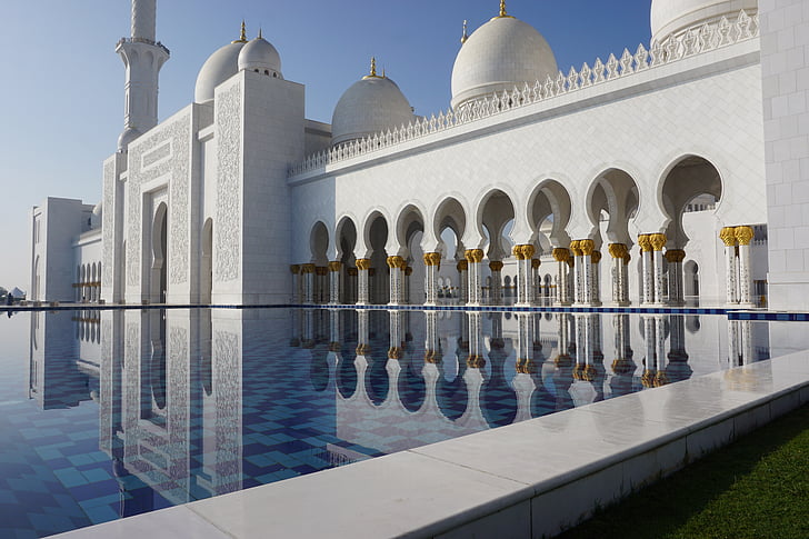 photography of white mosque with pool