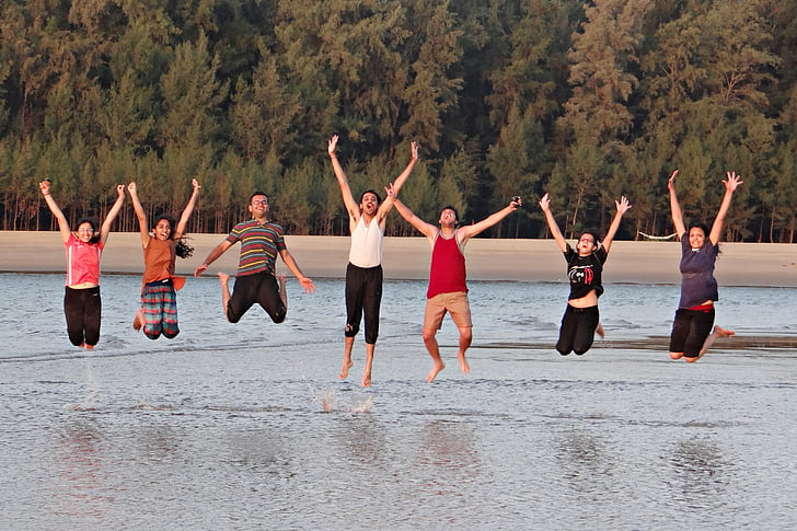 group of people jumpshot on the body of water