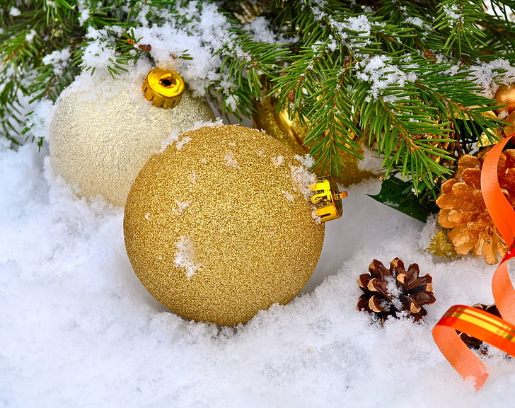 two brown and beige baubles on white snow