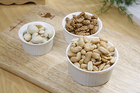 brown nuts and white eggs on white ceramic bowls