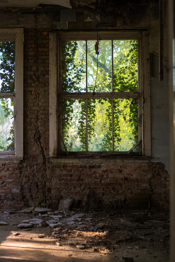 white framed window on brick wall