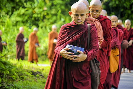 monk lining up beside the street