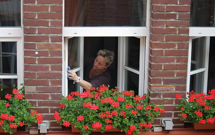 woman cleaning clear glass window