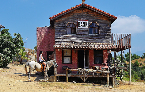 brown wooden 2-storey house with Bank signage