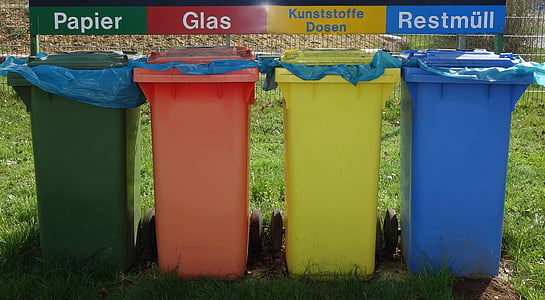four assorted-color plastic organized garbage bins