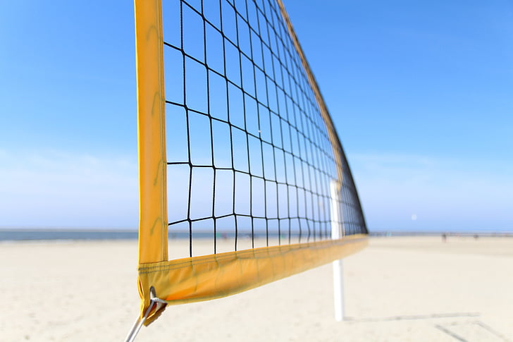close-up photography of yellow volleyball net on the beach