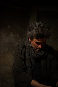 man wearing grey knit scarf