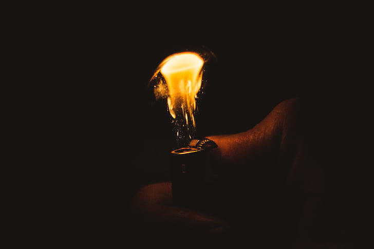 closeup photo of person using lighter
