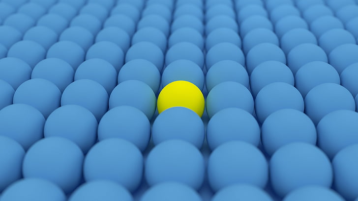 yellow ball surrounded by blue balls