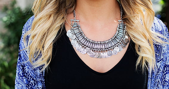 woman wearing silver-colored bib necklace