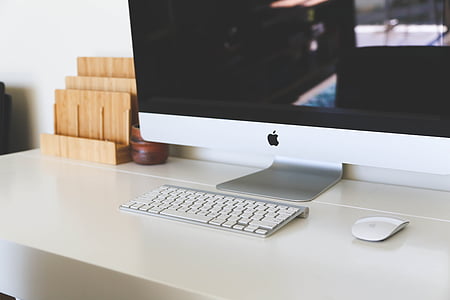 silver iMac with Magic Keyboard and Magic Mouse on white table