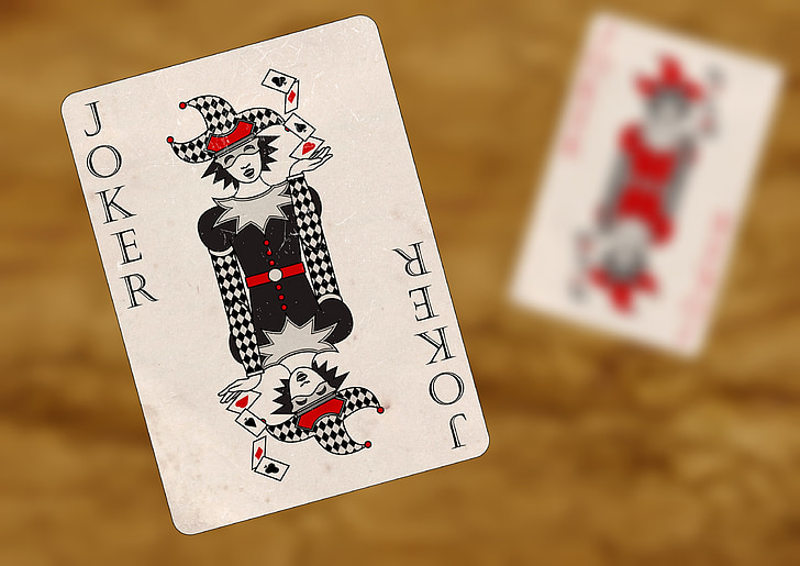red, gray, and black Joker playing card