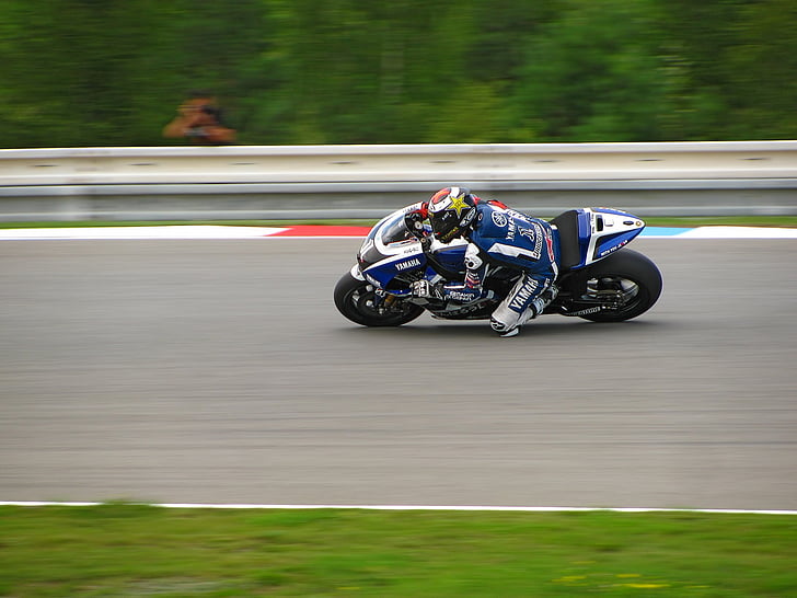 photo of man riding on a sports bike during race