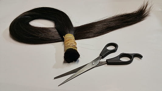black hair and black handle scissors
