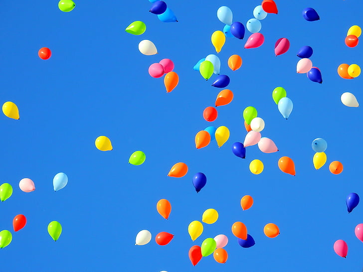 assorted-colored balloons floating in sky