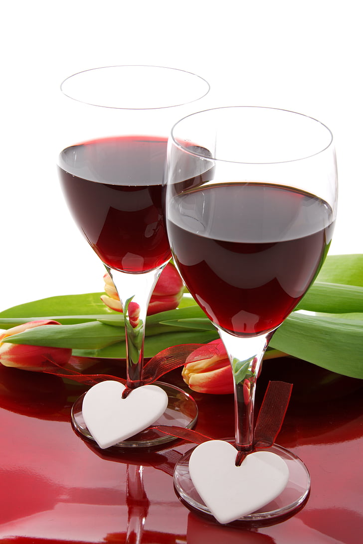 two red wine glasses filled with wine