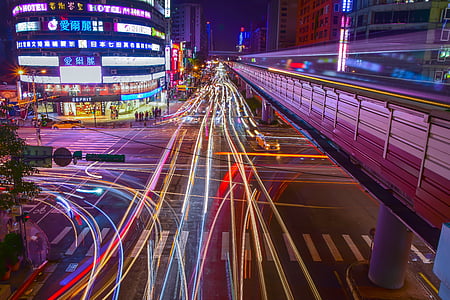 time lapse photography of road with vehicles and buildings