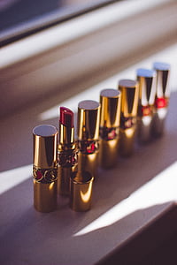 red lipsticks standing beside window