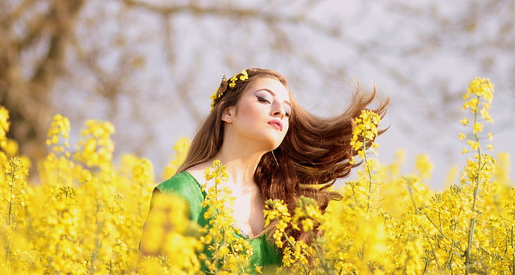 selective focus photography of woman wearing headpiece in field of yellow petaled flower