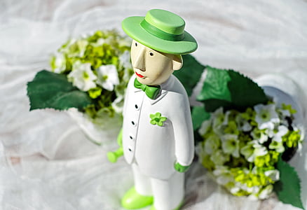 male character wearing white button-up jacket figurine near white petaled flower bouquet