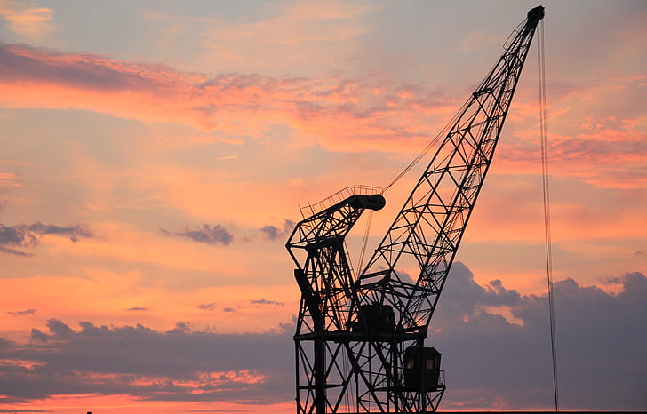 black metal crane at sunset