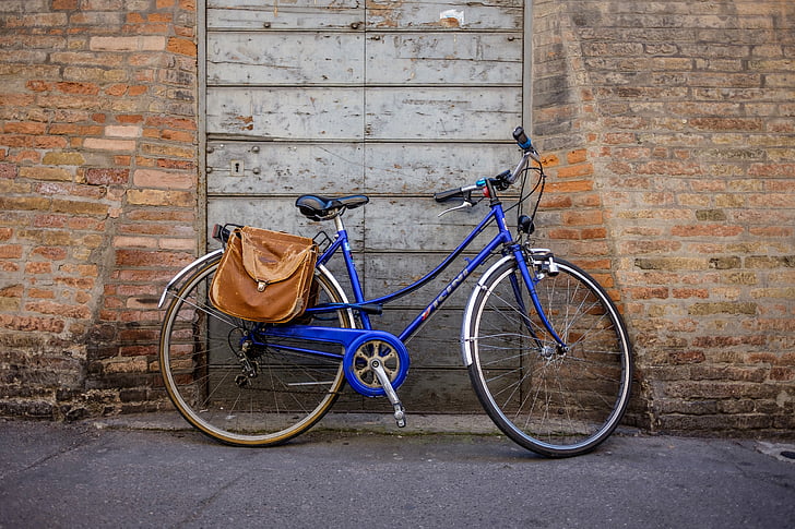blue and grey bicycle parked infront of door