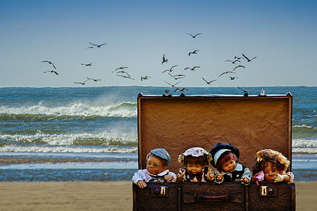 four dolls in chest trunk